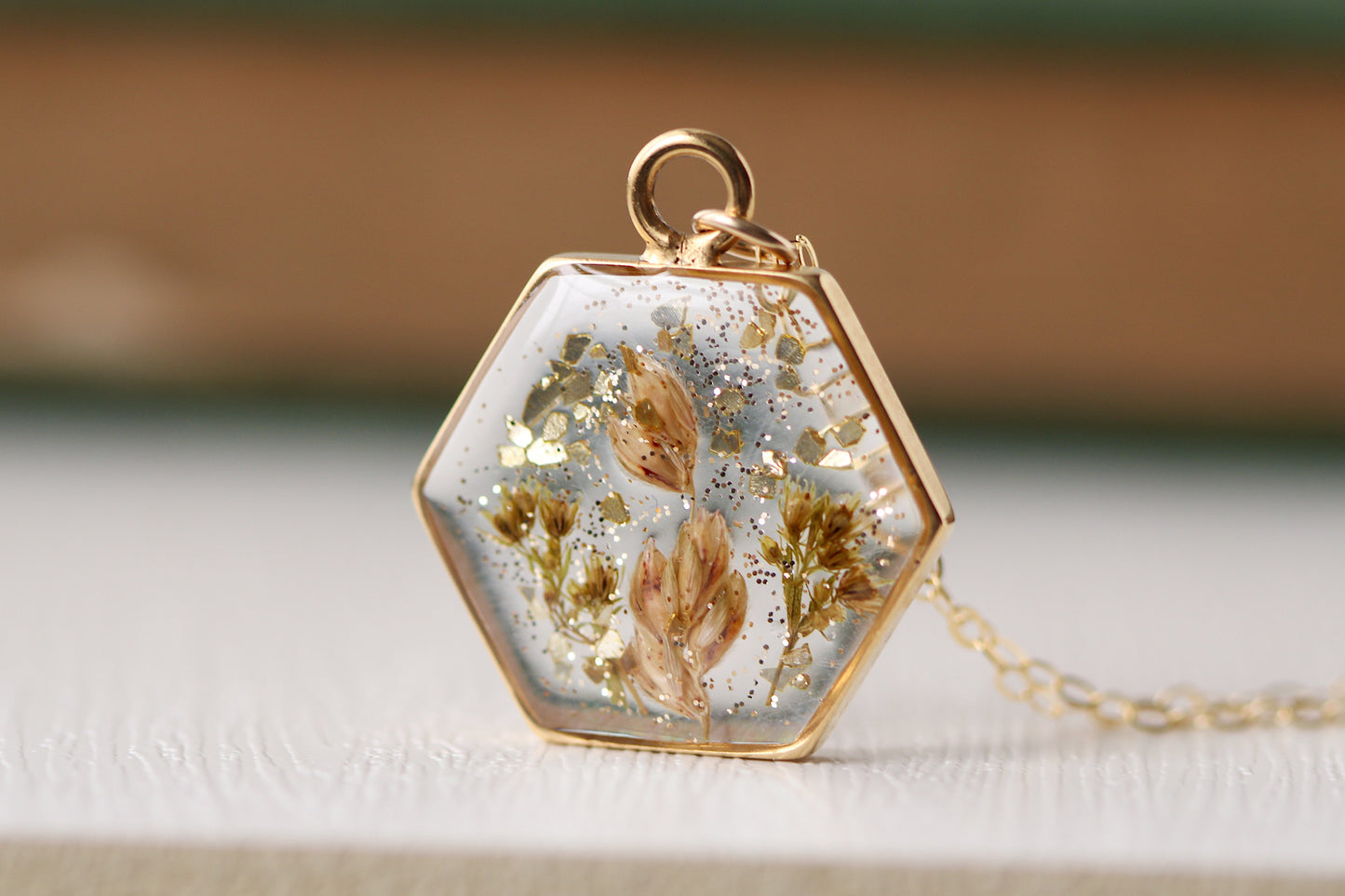handmade flowers in resin gold necklace, hexagon necklace with dried botanicals and glitter