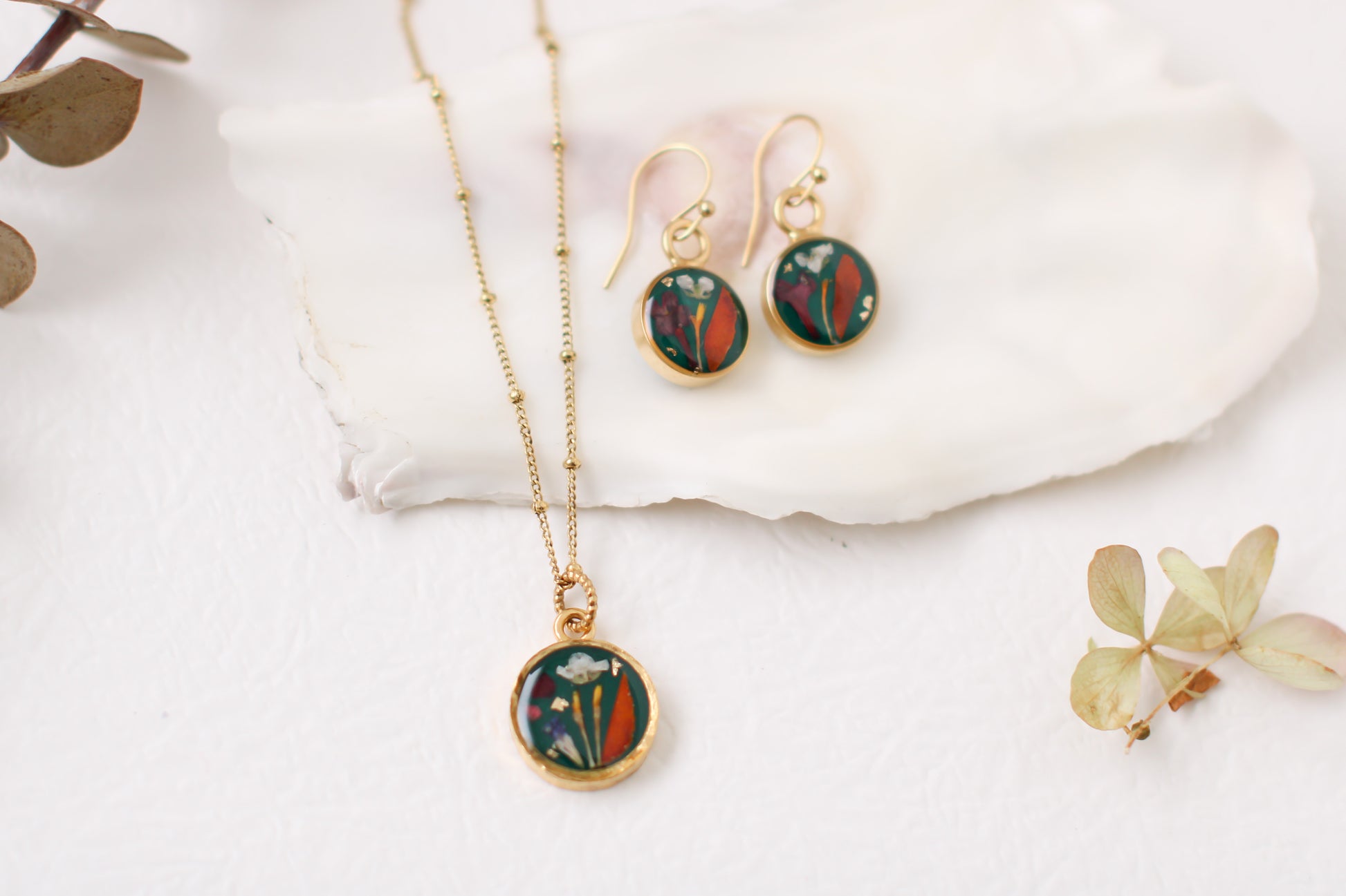 handmade dark green and gold small circle shaped dangle earrings with dried flowers and resin with matching necklace