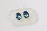 pair of handmade resin and clay blue and silver oval dangle earrings