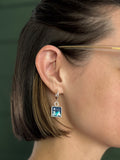 model wearing pair of blue and silver square dangle earings handmade resin and clay