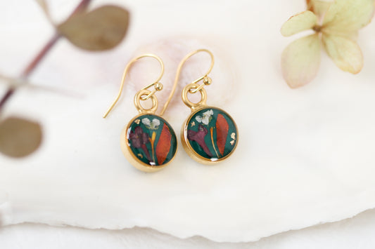 handmade dark green and gold small circle shaped dangle earrings with dried flowers and resin