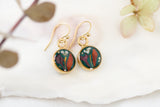 handmade dark green and gold small circle shaped dangle earrings with dried flowers and resin