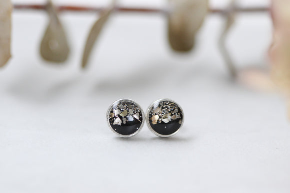 silver and black sparkly stud earrings made from epoxy clay, glitter and resin.  stainless steel posts.  handmade jewelry