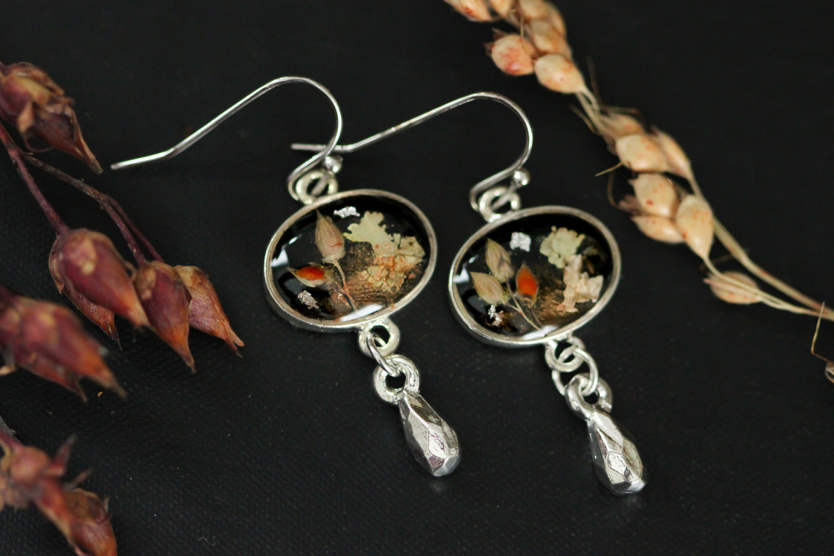 black and silver dangle earrings handmade from clay and resin featuring autumn inspired genuine plants, lichen and grains