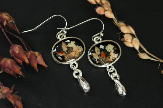 black and silver dangle earrings handmade from clay and resin featuring autumn inspired genuine plants, lichen and grains