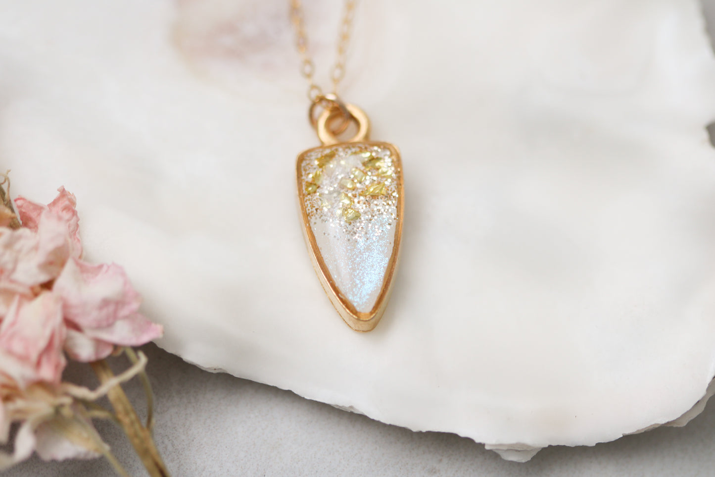 small gold sparkly pendant necklace on white background with flower, 18 inch gold filled chain