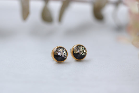 gold and black sparkly stud earrings made from epoxy clay, glitter and resin.  stainless steel posts.  handmade jewelry