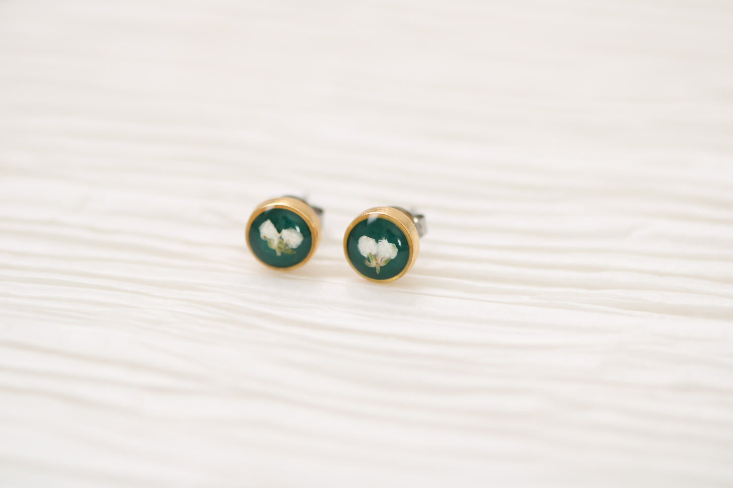 gold and dark green circle stud earrings with white dried alyssum flower handmade in clay with resin