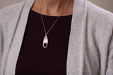 model wearing Silver oval shaped necklace with sparkle