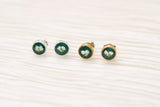 two pairs of earrings, a pair of gold and silver dark green circle stud earrings with white dried alyssum flower handmade in clay with resin