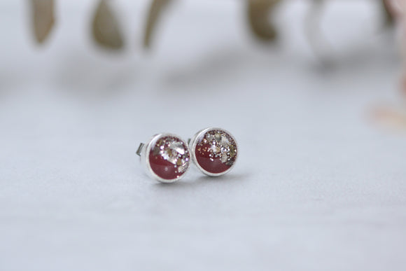 silver and burgundy sparkly stud earrings made from epoxy clay, glitter and resin.  stainless steel posts.  handmade jewelry