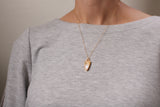 model wearing small gold sparkly pendant necklace with 18 inch gold filled chain