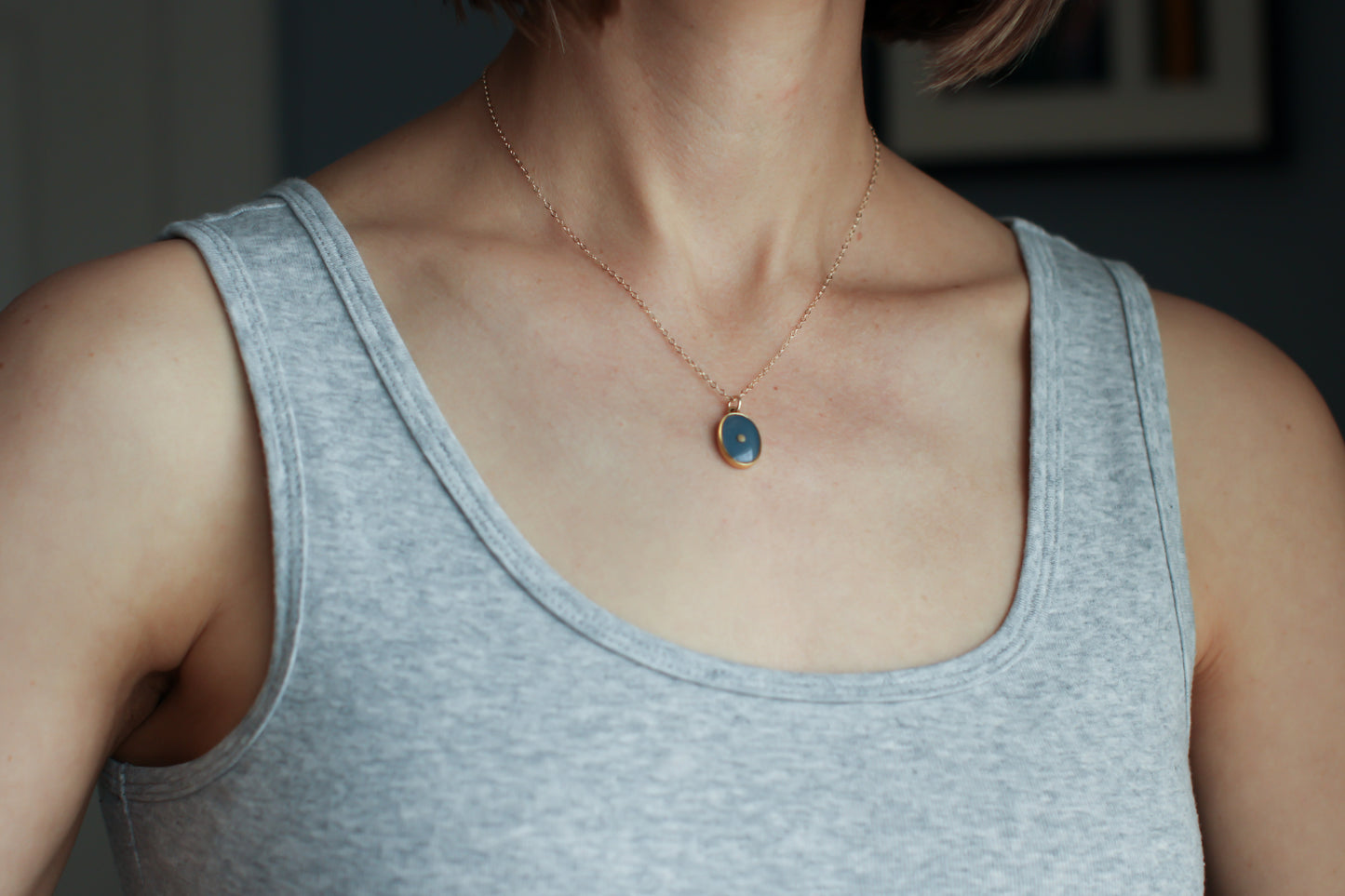 model wearing mustard seed necklace in gold