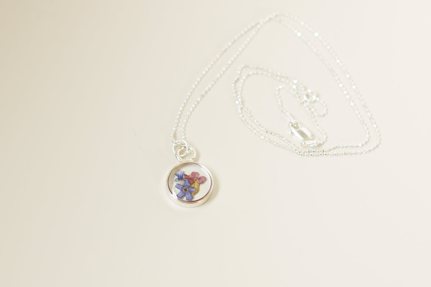 Silver Mini Circle Necklace with Blue Flowers