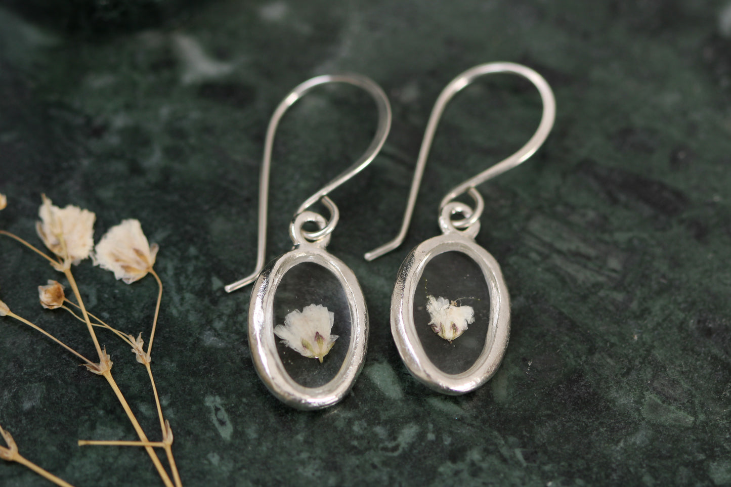 handmade silver oval clear resin dangle earrings with white baby's breath flower